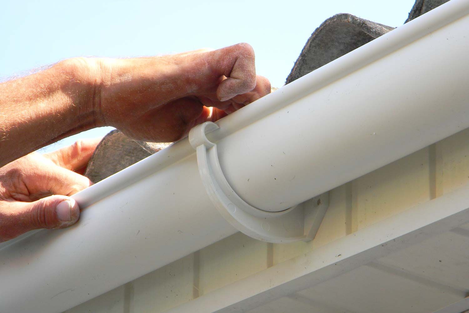 man fixing guttering